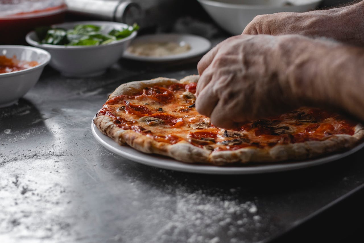 Man Hands over Pizza